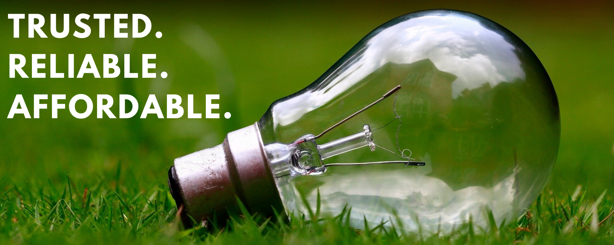 light bulb on green grass with words trusted reliable affordable