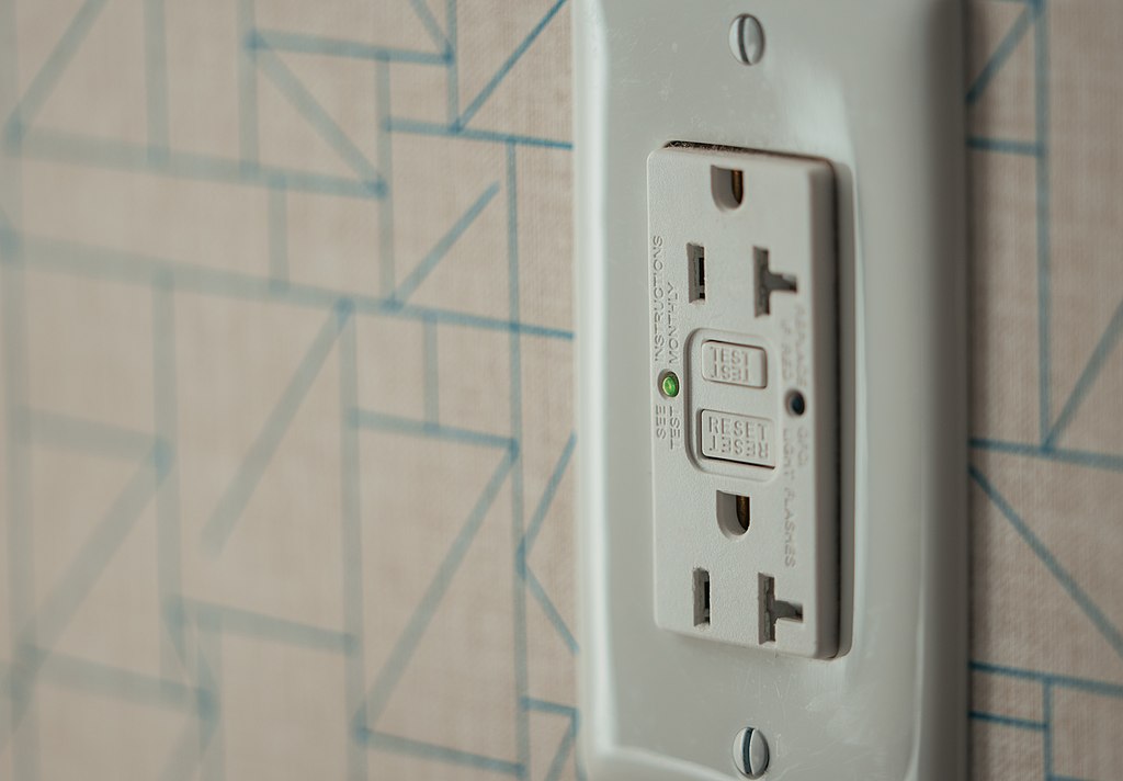 a gfci, a type of electrical outlet, with test buttons and LED