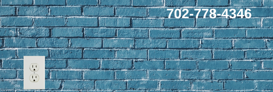 blue brick wall with white power outlet 702-778-4346